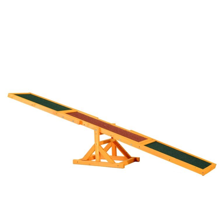 Wooden dog agility seesaw with green and red textured surfaces