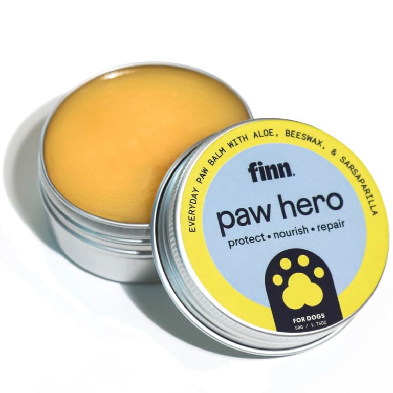 Dog paw balm in open tin, labeled "paw hero" with paw print icon