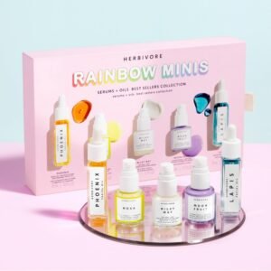 Herbivore Rainbow Minis skincare set with colorful serums and oils on a pink background