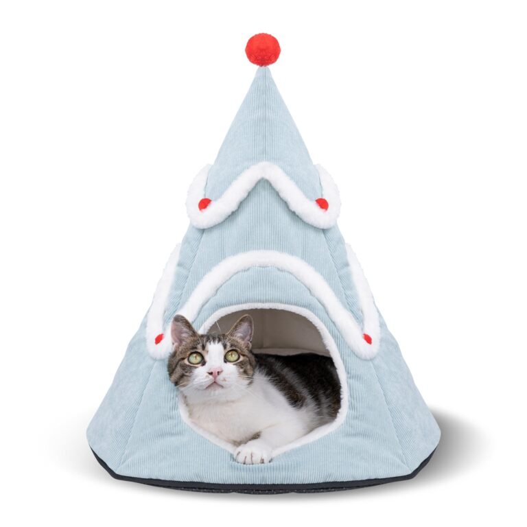 Cat in a blue Christmas tree-shaped bed with red pompom and trim